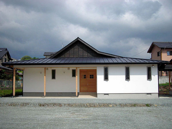木造　熊本T邸1、正面から見た住宅の全景、屋根の黒と漆喰の白のコントラストが特徴です